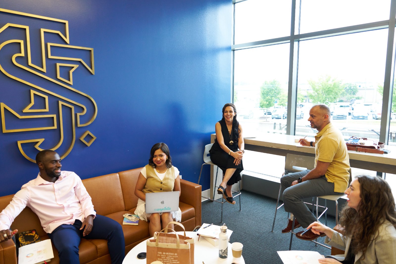 A small group of Mindset Groups members laughing together in conversation